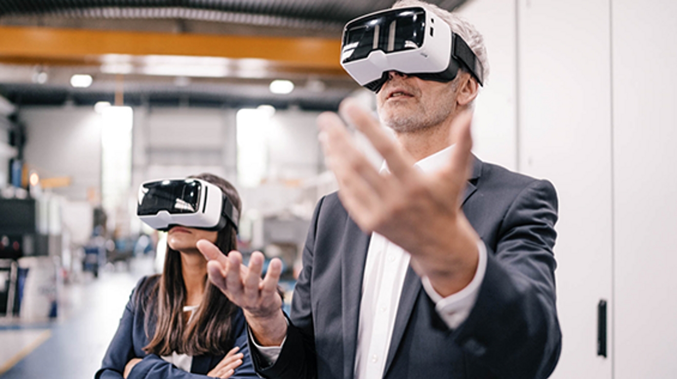 A man wearing virtual reality glasses making hand gestures in the air