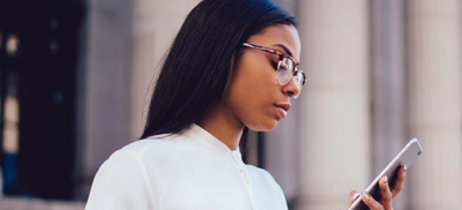 Business woman looking at phone.