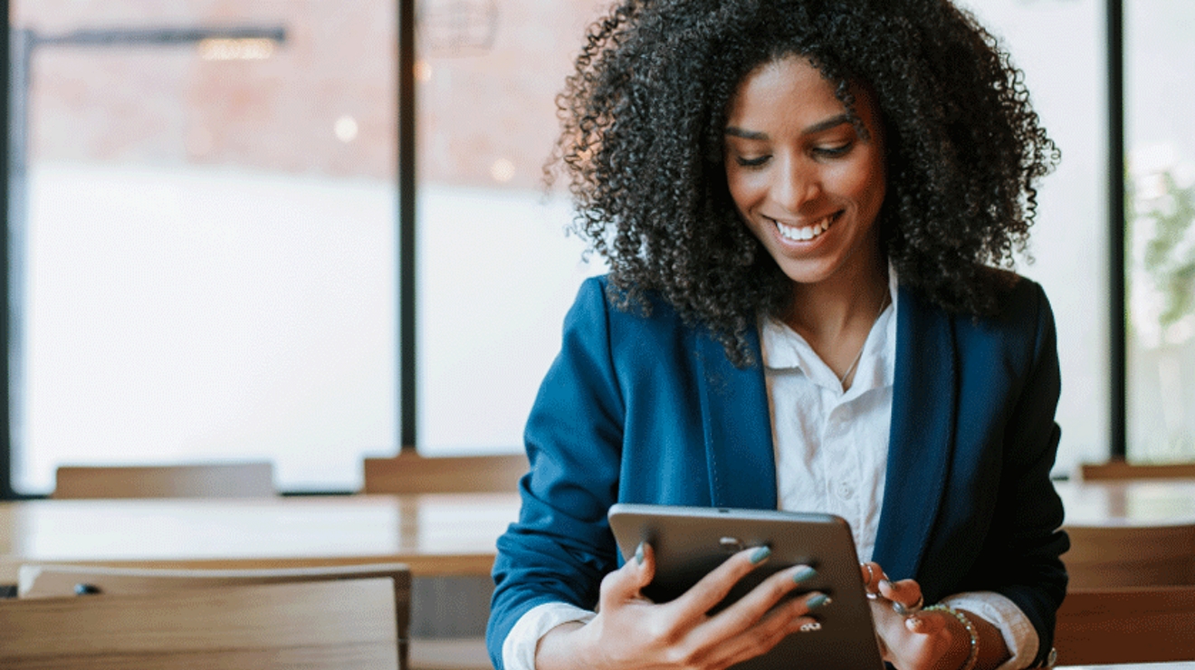 Smiling professional uses her tablet.