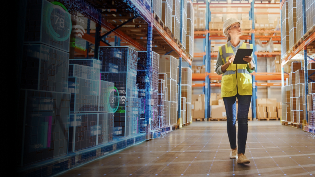 An employee uses a tablet to take inventory in an IoT-enabled retail warehouse.