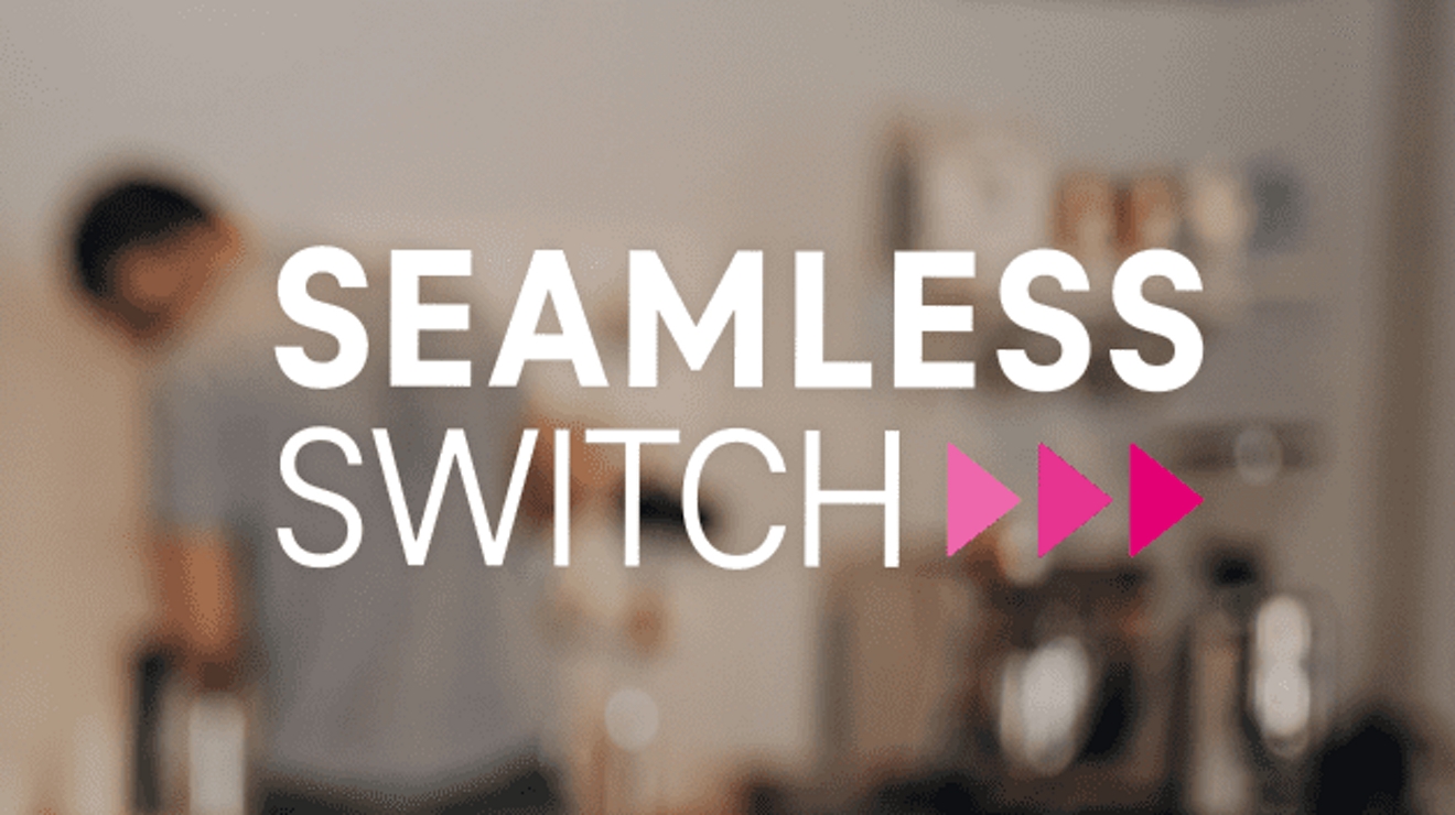 The Seamless Switch logo on a blurred background of a young man in an indoor setting.