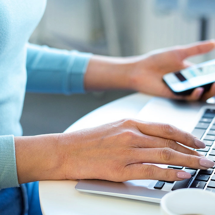 Person entering personal information into their mobile device.