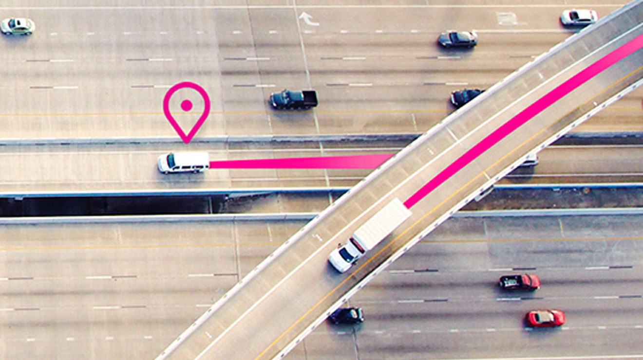 Overhead view of two white trucks on the highway with a location icon and magenta lines in back of vehicles