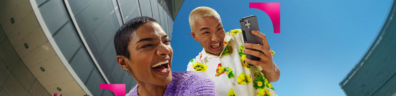 Two friends in colorful outfits laughing